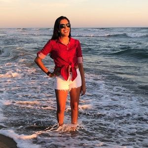 Red with white polka dot button up blouse.
